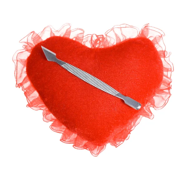 Shovel for manicure and a pedicure on a plush heart — Stock Photo, Image
