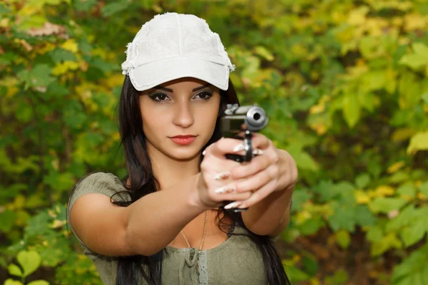 Het meisje met het pistool Stockfoto