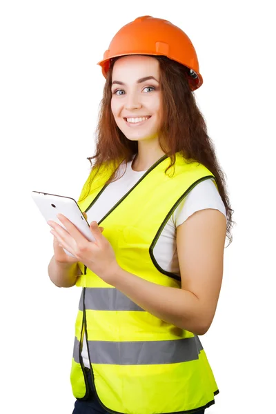 Das Mädchen der Bauarbeiter in Helm und Weste mit einem elektronischen Tablet in den Händen. Es ist isoliert. weißer Hintergrund. Stockfoto
