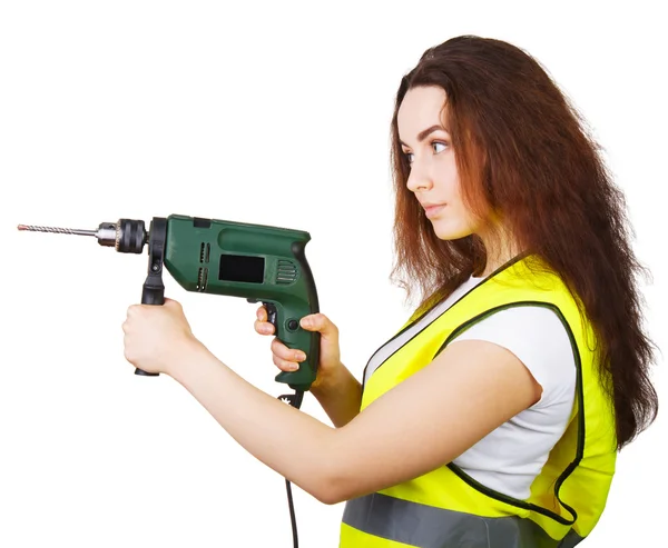 The girl in a construction vest with an electric drill in hands. — Stock Photo, Image