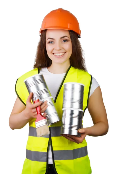 Chica en overol y un casco con latas de metal y un cepillo en las manos. aislamiento . — Foto de Stock