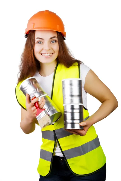 Chica en overol y un casco con latas de metal y un cepillo en las manos. aislamiento . — Foto de Stock