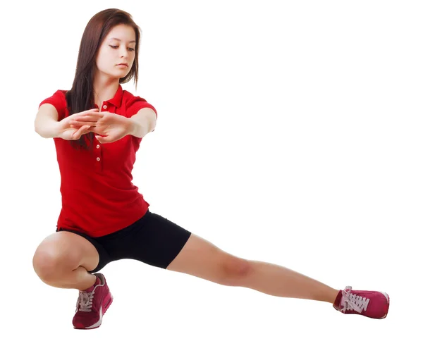 Jong meisje in korte broek en een shirt sport voert kraakpanden. geïsoleerd — Stockfoto