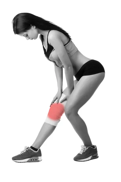 Athletic young woman with elastic bandage on his leg. Isolated Royalty Free Stock Images