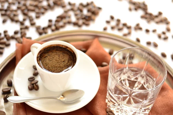 Cup of of coffee and glass of water on a tray — Stock Photo, Image