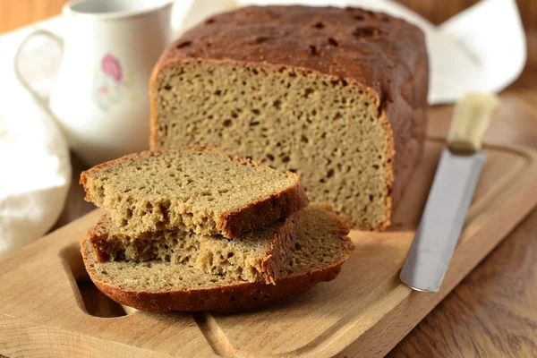 Freshly baked rye-wheat bread on a wooden board — Stock Photo, Image