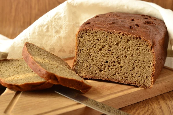 Freshly baked rye-wheat bread on a wooden board — Stock Photo, Image