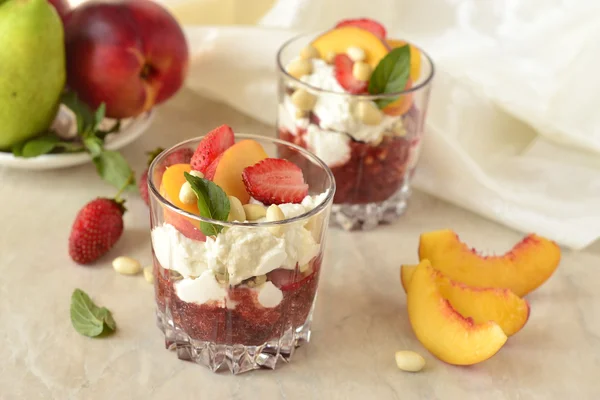 Dessert with whipped cream, fruit and nuts — Stock Photo, Image