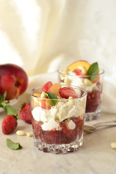 Dessert with whipped cream, fruit and nuts — Stock Photo, Image