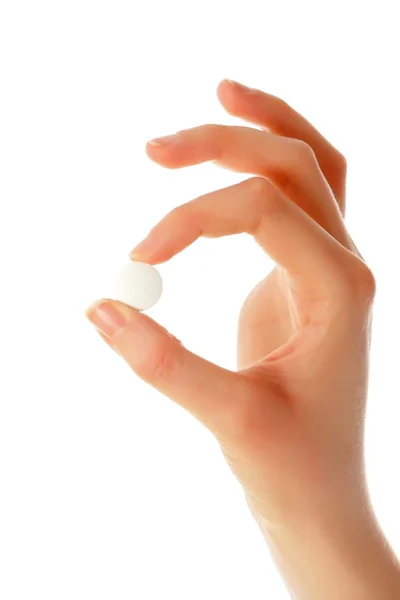 Beautiful hand holding a pill — Stock Photo, Image