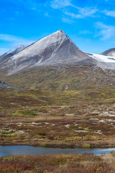 Yukon in Canada, mountains, wild landscape in autumn of the Tombstone park, the Dempster Highway, with a lake