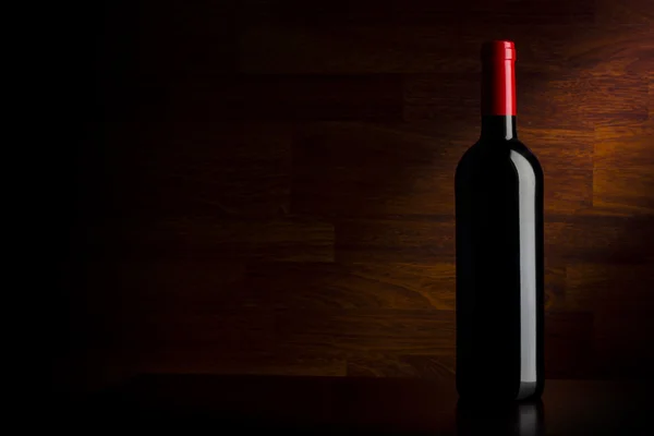 木製の背景にワインのボトル — ストック写真