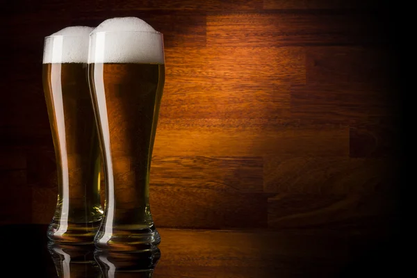 Two glass beer on wood background with copyspace — Stock Photo, Image