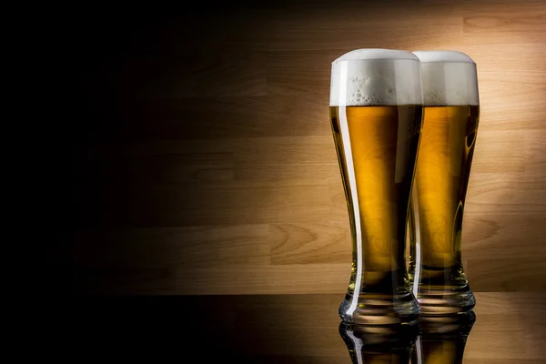 Two glass beer on wood background with copyspace — Stock Photo, Image