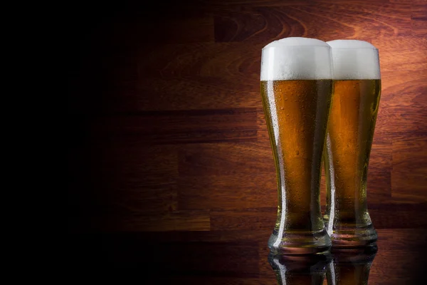 Two glass beer on wood background with copyspace — Stock Photo, Image