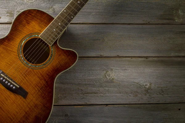 Acoustic guitar on wood background — Stock Photo, Image