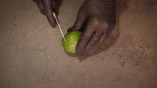 Людина розрізає вапно на шматки, використовуючи макрос гострим ножем — стокове відео
