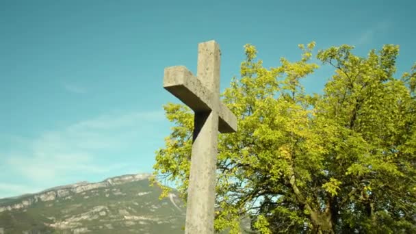 Steinkreuzdenkmal gegen Berge und Bäume im Park — Stockvideo
