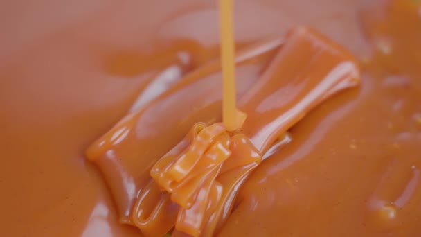 Вкусный ореховый коричневый карамельный соус падает в плесень — стоковое видео