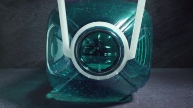 Gri masadaki büyük plastik su şişesinin içinde hareket