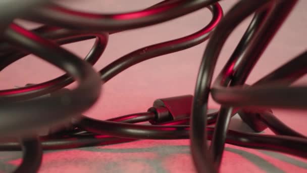 Tangled black wires at red artificial light of studio room — Vídeo de Stock