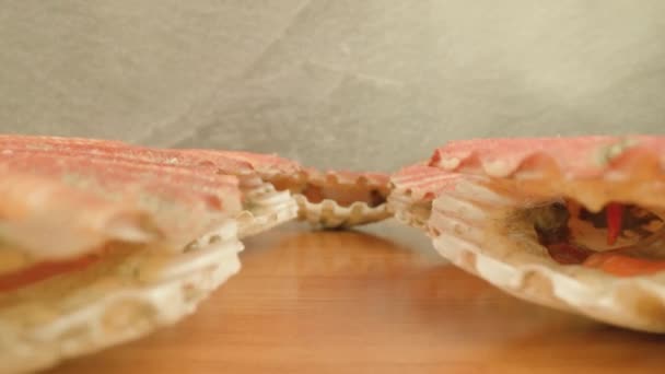 Des mollusques écarlates ouvrent de minces coquilles allongées sur la table — Video