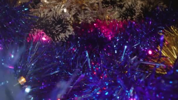 Mouvement le long d'une pile de guirlandes brillantes de tinsel d'arbre de Noël — Video