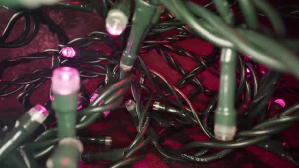 Tangled fairy lights coil with glowing lamps at Christmas — Stock Video