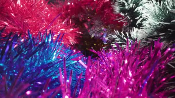 Motion over large pile of shiny tinsel garlands in studio — Stockvideo