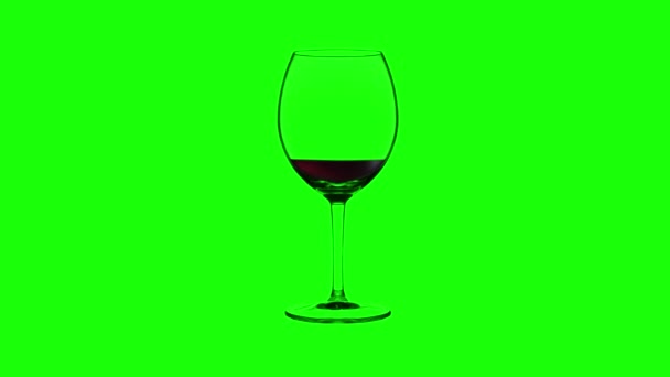 Empty wineglass filling up with red wine on green background — Stock Video