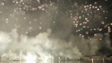 Bright colorful fireworks explode over Venice on Feast of Redemeer. Spreading smoke hides seafront. Traditional firework show on holiday in night city