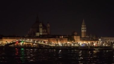 People walk on long pontoon bridge on Feast of Redeemer in Venice in late evening. Celebration of historical event in Italian city