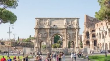 ROME, ITALY - MAY 12 2022: Tourists visit historical Arch of Constantine in center of Rome on sunny day. Ancient architecture in Italian city hyper lapse on May 12 in Rome