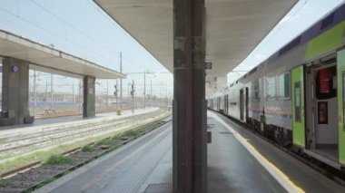 ROME, ITALY - MAY 12 2022: Train waits for passengers at Termini railway station in Rome. Urban infrastructure and railroad connecting major cities of Italy on May 12 in Rome