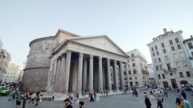 ROME, ITALY - MAY 12 2022: Tourists come to visit Pantheon located in center of Rome under blue sky. Famous ancient building with white columns in touristic city on May 12 in Rome