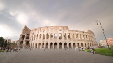 ROME, ITALY - MAY 12 2022: Famous Colosseum built in center of Rome under cloudy sky. Large elliptical amphitheater as major tourist historical attraction in Italy on May 12 in Rome