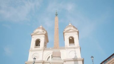 Church of Santissima Trinita dei Monti against blue sky in Rome. Ancient gothic building located in center of Italian capital low angle shot