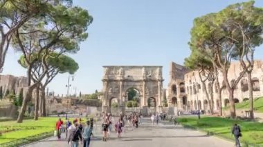 ROME, ITALY - MAY 12 2022: People sightseeing Arch of Constantine built near Colosseum on sunny day. Ancient architecture in historical center of Rome hyper lapse on May 12 in Rome