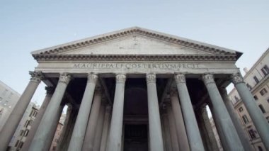 ROME, ITALY - MAY 12 2022: Entrance of ancient Pantheon built in Rome under blue sky. Historical building with white columns in Italian capital low angle shot on May 12 in Rome