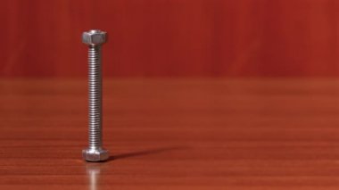 screw with bolt spinning on the table