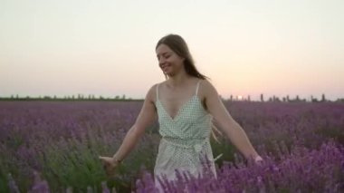 Woman runs on the lavender field in slow motion