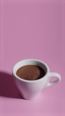 White cup fills with coffee