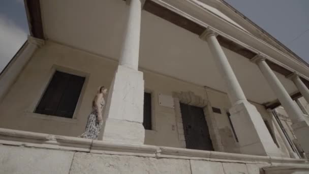 Woman Walks Talking Gesturing Her Hands Columns Building — Stockvideo