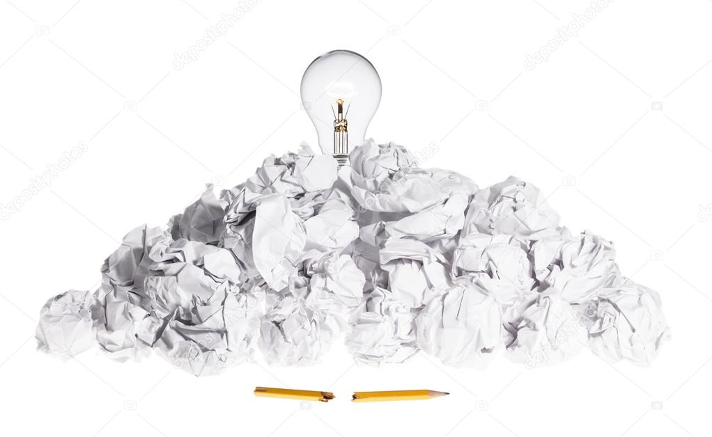 Problem Solving Concept Light Bulb On Pile of Crumpled Paper