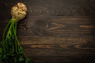 Ahşap arka planda yeşil yapraklı kök sebze kerevizi, çiftlik sebzeleri.