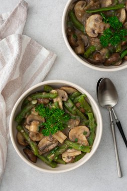 Yeşil soğan ve maydanozlu krema soslu yeşil fasulyeli kızarmış kahverengi mantar.