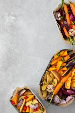 Çeşitli seramik tabaklarda fırında kızartılması için taze sebzeler, üst manzara.