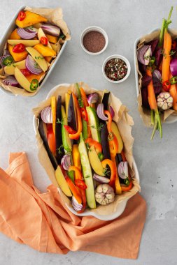 Çeşitli seramik tabaklarda fırında kızartılması için taze sebzeler, üst manzara.