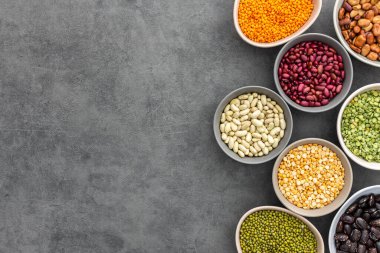 Kâselerdeki farklı baklagiller, sarı ve yeşil bezelyeler ve mercimek, renkli fasulyeler ve lapa, üst görünüm, kopyalama alanı
