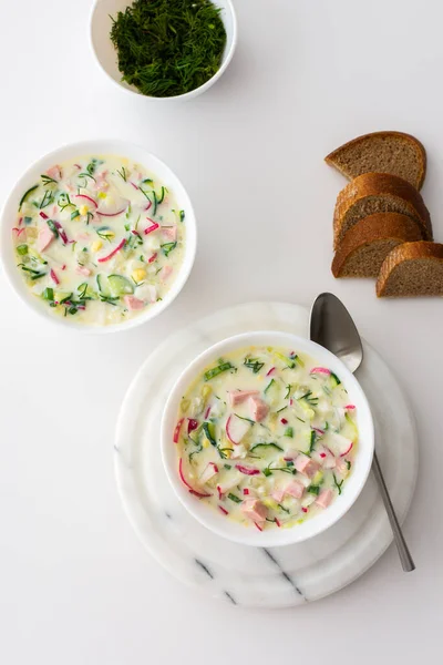 Cold soup Okroshka, soup with fresh vegetables and kefir, delicious summer traditional Ukrainian or Russian soup